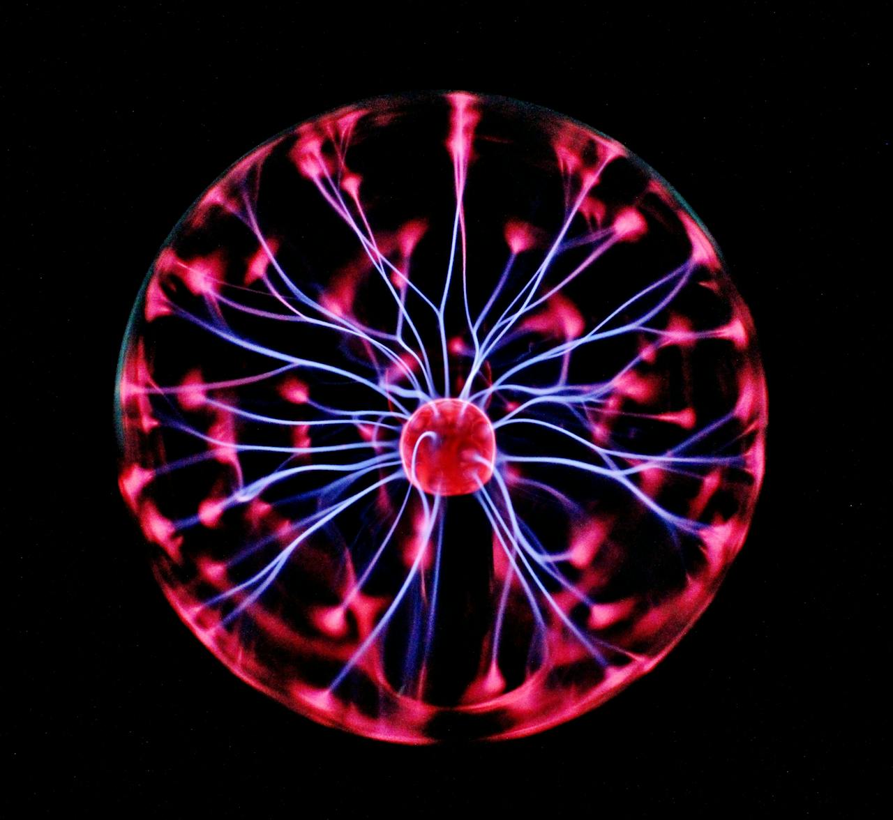 creative-03 Close-up of a plasma globe with vibrant neon sparks against a dark background.
